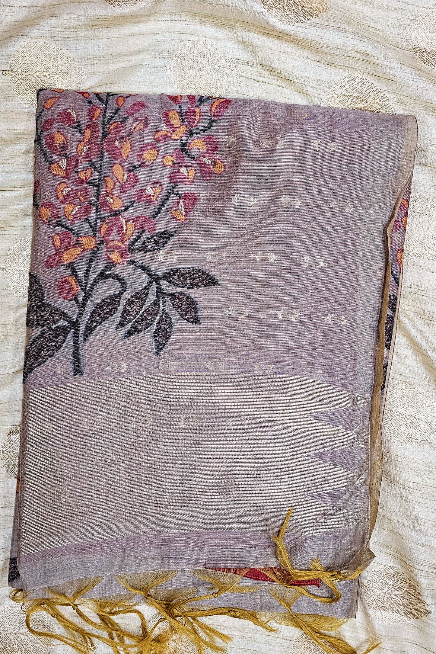 Organic tussar silk saree in a mute greyish purple shade with floral weaving in contrasting colors