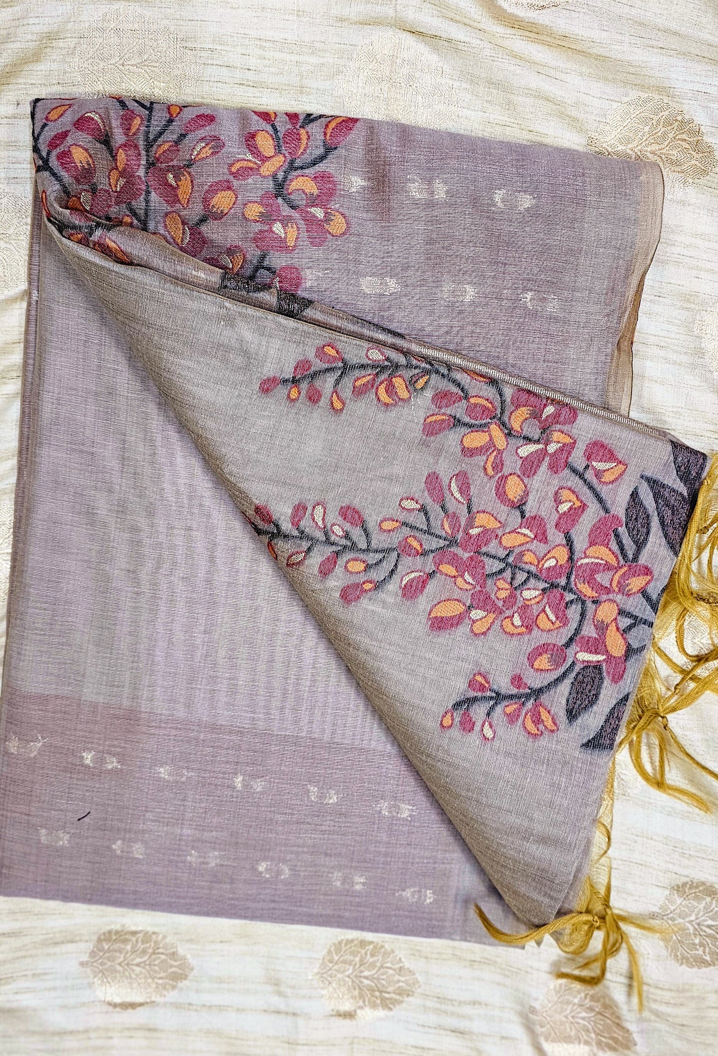 Organic tussar silk saree in a mute greyish purple shade with floral weaving in contrasting colors