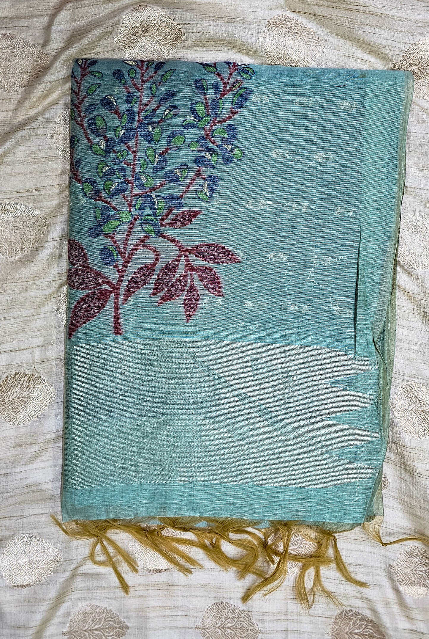 Organic tussar silk saree in beautiful mite teal shade with floral weaving in contrasting colors.