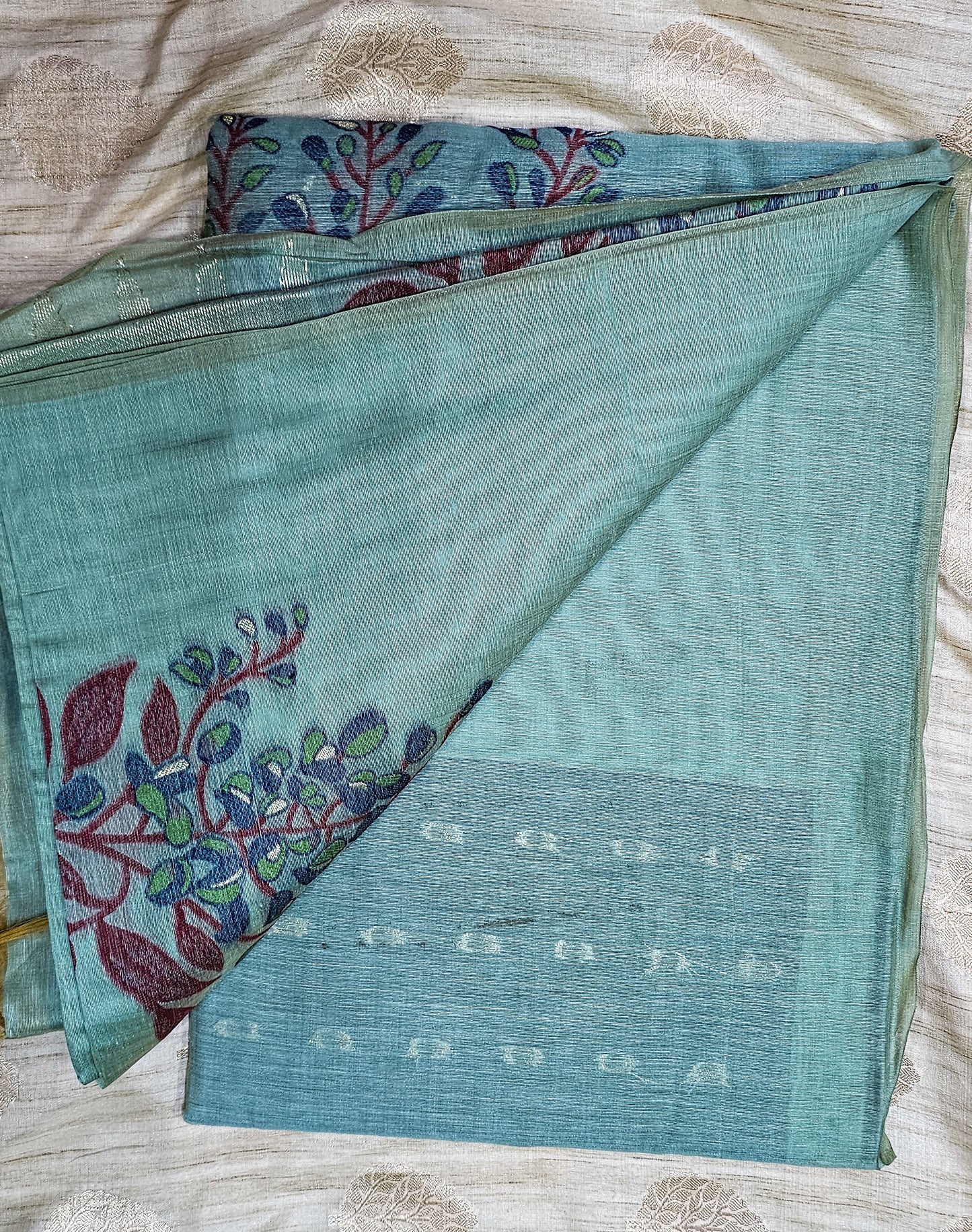 Organic tussar silk saree in beautiful mite teal shade with floral weaving in contrasting colors.