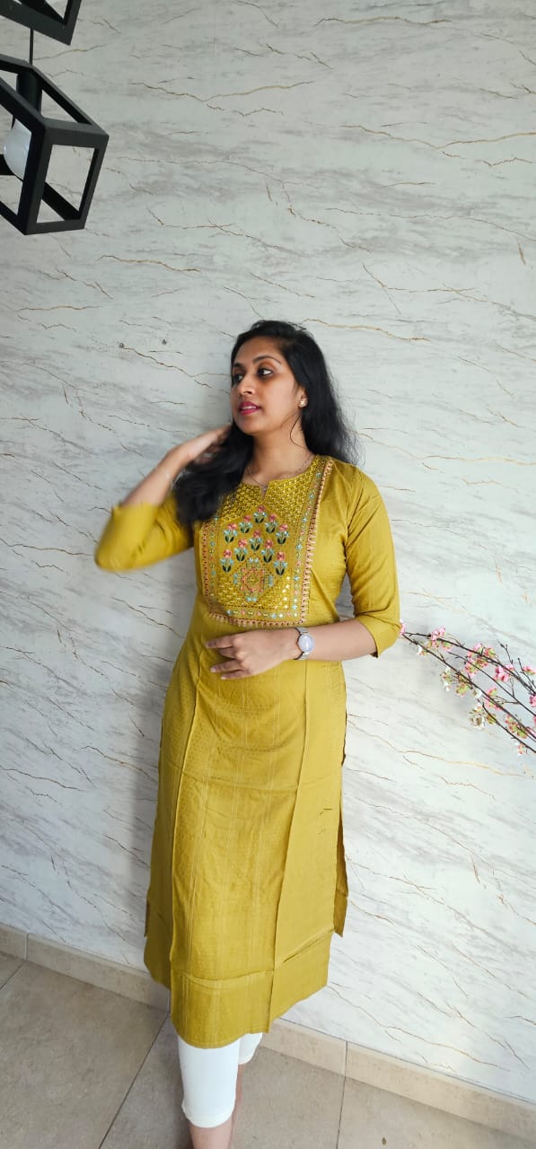 Cotton kurti in mustard yellow shade with a warm undertone.